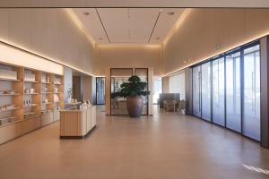 a lobby with a plant in the middle of a building at JI Hotel Vientiane Mekong Riverside in Vientiane +43 photos