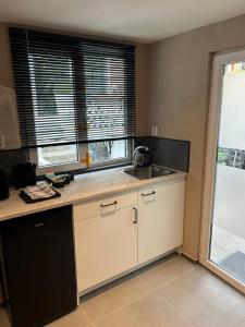 an empty kitchen with a sink and a window at Tiny House Beachroom in Scheveningen