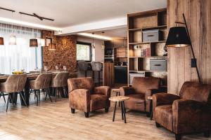 a living room with a table and chairs and a kitchen at Chalet Amadeus by we rent in Piesendorf