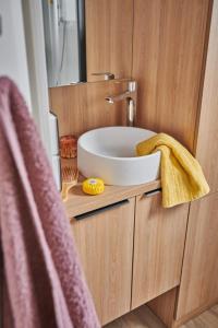 a bathroom with a sink and a mirror at Camping l'Oso in Porto-Vecchio +61 photos