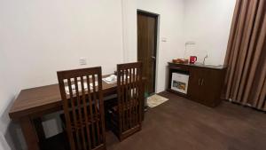 a room with a desk and a table and chairs at Villa Mistica - Hiriketiya Dikwella in Dickwella