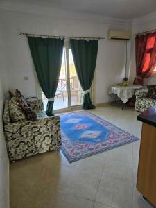 a living room with a couch and a window at Pool & Beach Apartment in Sharm El Sheikh +21 photos