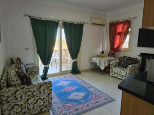 a living room with two chairs and a rug at Pool & Beach Apartment in Sharm El Sheikh