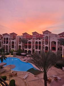 a view of the resort at sunset at Pool & Beach Apartment in Sharm El Sheikh