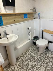 a bathroom with a sink and a toilet at Yellowhammer Hut at Carr House Farm in Cayton +31 photos