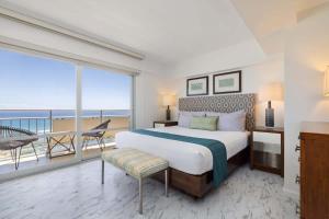 a bedroom with a large bed and a balcony at #Marbella Lane - Luxe 2BR with Panoramic Ocean View in Honolulu +18 photos