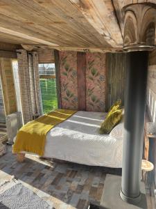 a bedroom with a bed in a room at Yellowhammer Hut at Carr House Farm in Cayton