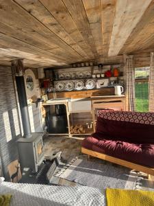 a living room with a couch and a stove at Yellowhammer Hut at Carr House Farm in Cayton