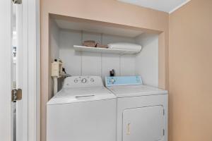 a white washer and dryer in a small room at Boston Condo With FREE Parking in Boston