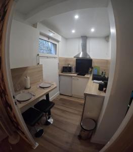 a small kitchen with a table and two chairs at le Thermal 108 in Saint-Martin-d'Uriage +11 photos