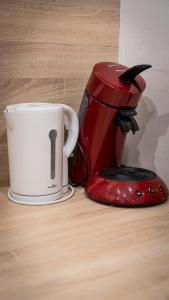a coffee maker and a coffee cup on a table at le Thermal 108 in Saint-Martin-d'Uriage