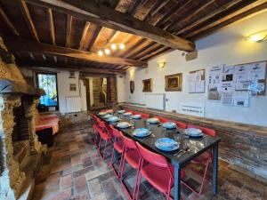 a dining room with a long table and red chairs at Vacation Home Tuscany Pisa-Lucca 2 in Filettole