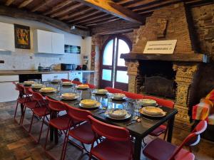 a dining room with a long table and red chairs at Vacation Home Tuscany Pisa-Lucca 2 in Filettole +18 photos