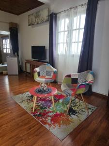 a living room with two chairs and a rug at Le Paille en Queue in Saint-Louis