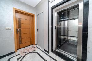 a wooden door in a room with a window at Luxury Abraj YK 120m2 in Tangier +55 photos