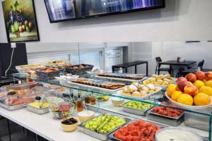 a buffet with many different types of fruits and vegetables at New Amaryllis Hotel in Athens