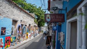 a street in an alley with a sign for a hotel at Art Hotel Getsemani in Cartagena de Indias