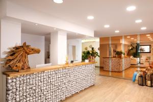 a lobby with a counter with a horse head on it at Hotel Bellariva in Lido di Jesolo
