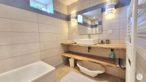 a bathroom with a toilet and a sink and a mirror at Le Petit Mingot in Druy-Parigny +19 photos