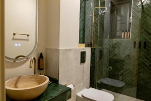 a bathroom with a bowl sink and a shower at Habitat Suites - Modern Apartments with Terraces and Free Parking in Craiova +34 photos