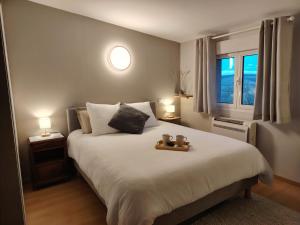 a bedroom with a bed with two teddy bears on it at Maison d'hôtes Beauregard in Donneville +22 photos