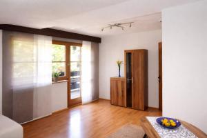 an empty living room with a table and a door at Apartment Fischer in Tarrenz