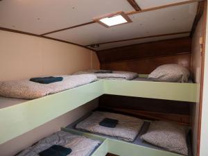 a room with four bunk beds in a room at FLOW in Amsterdam