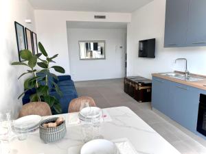 a kitchen and dining room with a white table and chairs at Jungle - Sarnico Color Suites in Sarnico