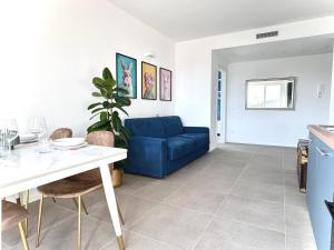 a living room with a blue couch and a table at Jungle - Sarnico Color Suites in Sarnico