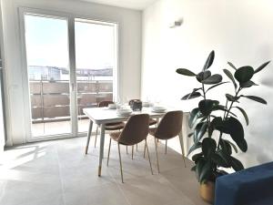 a dining room with a table and a potted plant at Jungle - Sarnico Color Suites in Sarnico