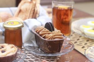 a table with a cup of chocolate pudding and cookies at World Inn by WIH in Karachi +186 photos