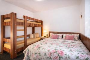 a bedroom with a bed and a bunk bed at Piemonti Bešeňová in Bešeňová +25 photos