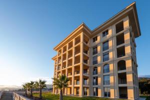 an office building with palm trees in front of it at VillaPignone in Genoa
