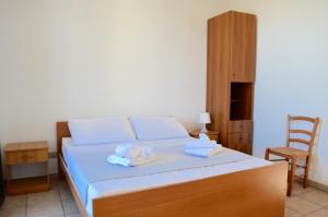 a bedroom with a bed with towels on it at Mya Vacanze in Torre dell'Orso