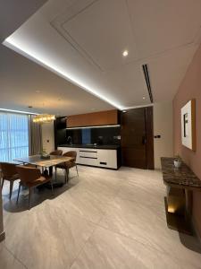a kitchen and dining room with a table and chairs at Zipp Hotel Rosalba in Bangalore