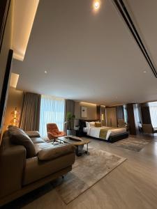 a living room with a couch and a bed at Zipp Hotel Rosalba in Bangalore