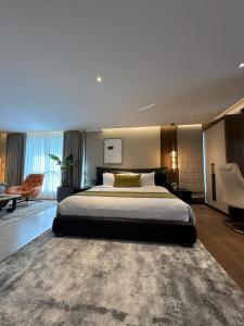 a bedroom with a large bed and a large rug at Zipp Hotel Rosalba in Bangalore +67 photos