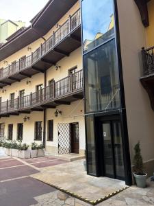 an external view of a building with a large glass doorway at Hetman Main Square Apartments in Krakow