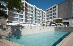 a swimming pool in front of a large building at Hotel Slavey - All Inclusive in Golden Sands