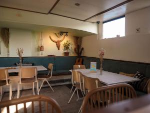 a restaurant with two tables and chairs and a guitar at FLOW in Amsterdam +34 photos