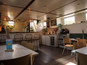 a restaurant with tables and chairs and a kitchen at FLOW in Amsterdam