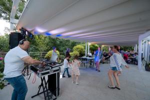 a group of people standing around a grill at Hotel Slavey - All Inclusive in Golden Sands +25 photos