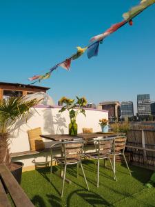 a patio with a table and chairs on a balcony at FLOW in Amsterdam