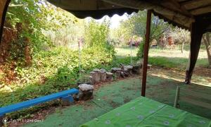 a picnic table under a tent in a garden at Граничар 3 СЪРФА - морската каюта in Granichar