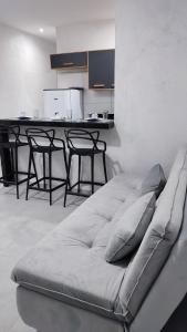 a couch sitting in a room with a kitchen at Águas de Maragogi residence in Maragogi