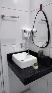 a bathroom with a white sink and a mirror at Águas de Maragogi residence in Maragogi +11 photos