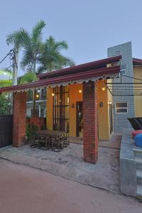 a building with a patio with a table and chairs at Canal's Edge in Negombo