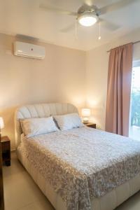 a bedroom with a bed and a window at Residencial Esprit Caribbean in Bayahibe +10 photos