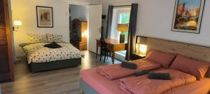 a living room with a couch and a bed at Le Grand Barrois in Crécy-la-Chapelle