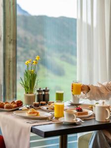 a breakfast table with breakfast foods and orange juice at Taverne 1879 - Bürgenstock Resort Lake Lucerne in Bürgenstock +29 photos